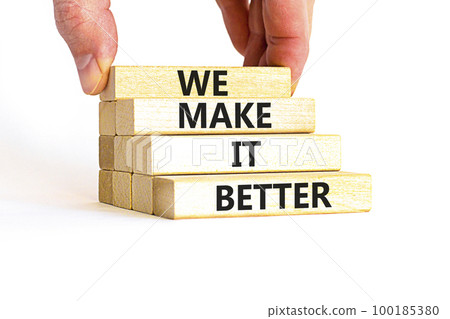 We make it better symbol. Concept words We make it better on wooden blocks. Beautiful white table white background. Businessman hand. Business we make it better concept. Copy space. 100185380