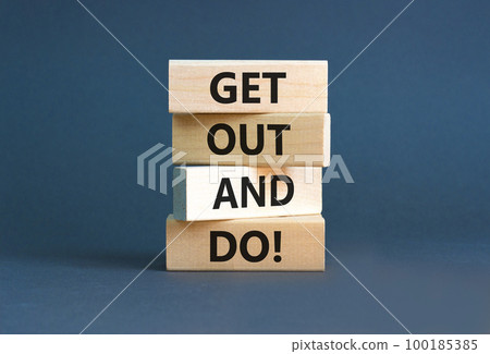Motivational get out and do symbol. Concept words Get out and do on wooden cubes. Beautiful grey table grey background. Business motivational get out and do concept. Copy space. 100185385