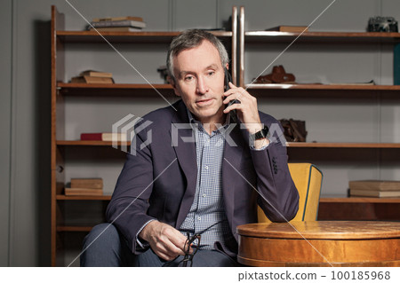 Serious elderly grey haired attractive businessman 100185968