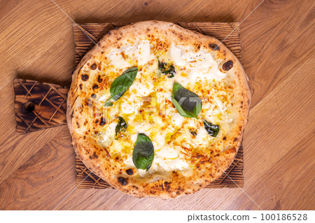 Delicious pizza Formaji with Provala, Parmesan, Mozzarella, Gorgonzola and basil Delicious pizza Formaji with Provala, Parmesan, Mozzarella, Gorgonzola and basil 100186528