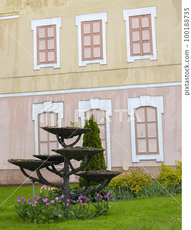 Outdoor stand for flowers, ridiculous design of small architectural forms. Empty places in the flowerbed Outdoor stand for flowers, ridiculous design of small architectural forms. Empty places in the flowerbed 100188735