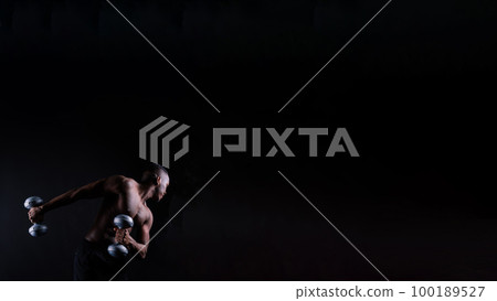 Muscular black african man with defined muscles abs abdominal, exercise determination and success 100189527