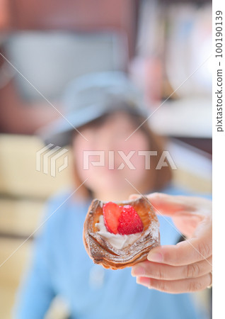 A woman eating a fruit tart Tea time in a camper 100190139