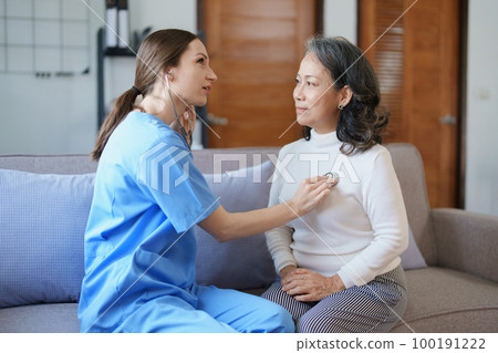 Portrait of a female doctor using a stethoscope to check the pulse of an elderly patient Portrait of a female doctor using a stethoscope to check the pulse of an elderly patient 100191222
