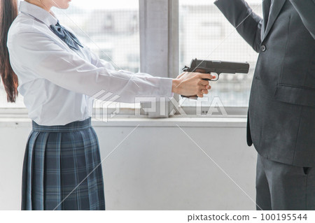 A high school girl who sticks out a handgun / pistol to a man (injury, self-defense, crime, intimidation,) 100195544