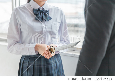 A high school girl points a knife at a man (assault, self-defense, crime, intimidation) 100195545