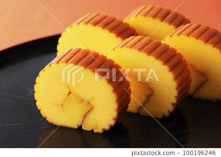 Datemaki tamago on a black tray Datemaki tamago on a black tray 100196246