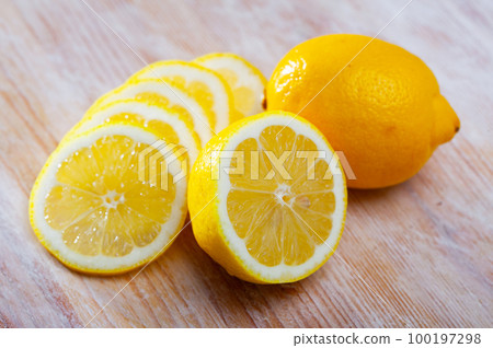 Lemon slices on wooden background Lemon slices on wooden background 100197298