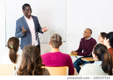 African american teacher at university with multinational students 100197583