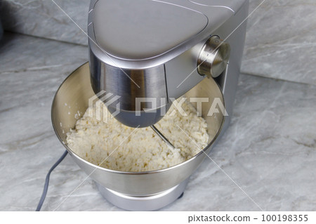 Kneading dough in the modern kitchen machine on a table 100198355