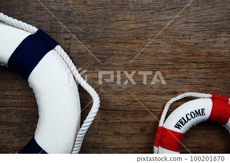 Nautical Lifebuoy with space copy on wooden background 100201870