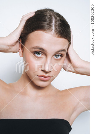 Close up beauty portrait of young girl with fresh skin tone on white background isolated Close up beauty portrait of young girl with fresh skin tone on white background isolated 100202309