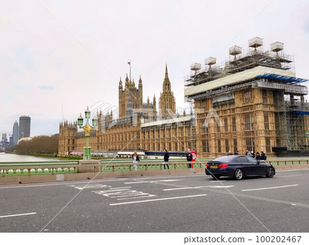 The partially repaired British Houses of Parliament standing on the banks of the River Thames and the fully repaired clock tower. England London The partially repaired British Houses of Parliament standing on the banks of the River Thames and the fully repaired clock tower. England London 100202467