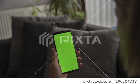 Midsection of woman using mobile phone  Close-up Smartphone with Green Chroma Key Screen. 100204738