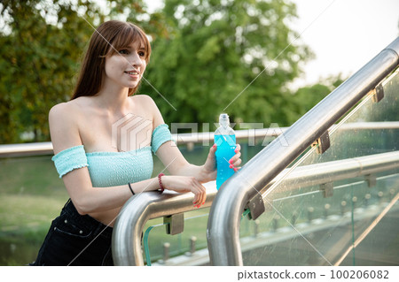 Smiling brunette in summer outfit, with long fringe Smiling brunette in summer outfit, with long fringe 100206082
