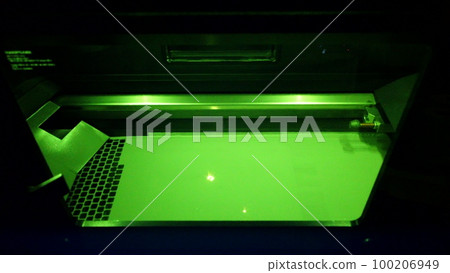 Working 3d printer for metal. 3D printer printing object from metal powder in working chamber by sintering metal powder under laser. SLM. Selective laser melting technology. Melting metal powder 100206949