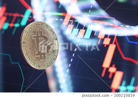 Bitcoin coins with global trading exchange market price chart in the background. Bitcoin coins with global trading exchange market price chart in the background. 100210859