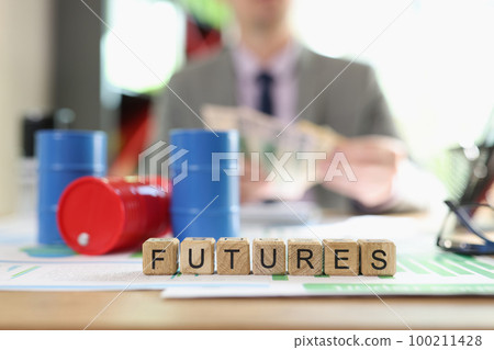 Letters futures collected from cubes and oil barrels on financial documents. 100211428