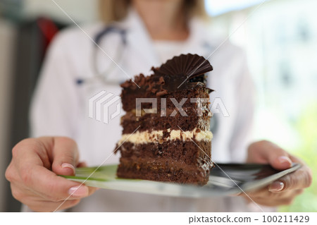 Female dietologist ask avoiding unhealthy sweet foods. Female dietologist ask avoiding unhealthy sweet foods. 100211429