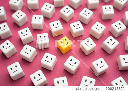 Smiling yellow amprophomorphic face among many indifferent neutrals. One of the kind. Inspiration and optimism. Good mood. Feeling great. 100213851