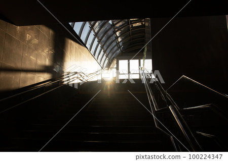 Sunlight on a dark staircase close up 100224347