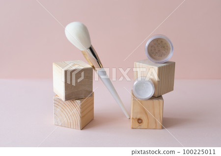 Cosmetic set of various shades compact face mineral powder and makeup brush on pastel background. Natural eco friendly make up products concept 100225011