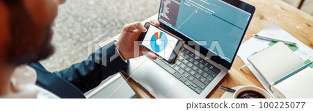 Young developer programmer freelancer in glasses working on project in cafe. Blurred background 100225077