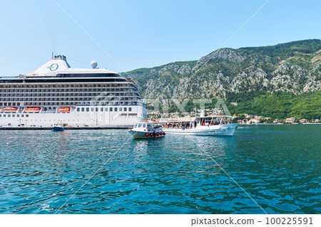 Picturesque panoramic view of Bay of Kotor, mountains and a tourist liner. Montenegro, Europe. Picturesque panoramic view of Bay of Kotor, mountains and a tourist liner. Montenegro, Europe. 100225591