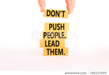 Push or lead people symbol. Concept words Do not push people lead them on wooden blocks. Beautiful white table white background. Businessman hand. Business Push or lead people concept. Copy space. Push or lead people symbol. Concept words Do not push people lead them on wooden blocks. Beautiful white table white background. Businessman hand. Business Push or lead people concept. Copy space. 100225939