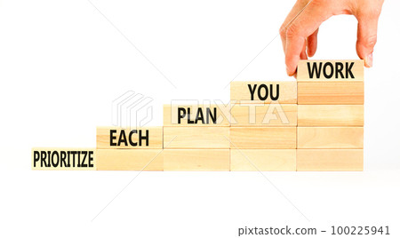 Prioritize each plan you work symbol. Concept words Prioritize each plan you work on blocks on beautiful white background. Businessman hand. Business prioritize each plan you work concept. Copy space 100225941