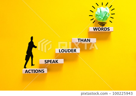Actions speak louder words symbol. Concept words Actions speak louder than words on wooden blocks. Beautiful yellow table yellow background. Business new mindset for results concept. Copy space. 100225943