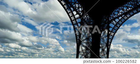 Eiffel Tower against the background of a beautiful sky with clouds. Paris, France Eiffel Tower against the background of a beautiful sky with clouds. Paris, France 100226582