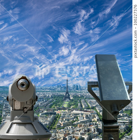 Telescope viewer and city skyline at daytime (against the background of very beautiful clouds). Paris, France. 100227376