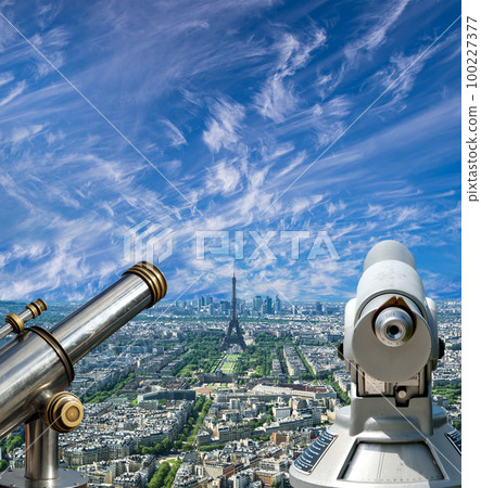 Telescope viewer and city skyline at daytime (against the background of very beautiful clouds). Paris, France. 100227377