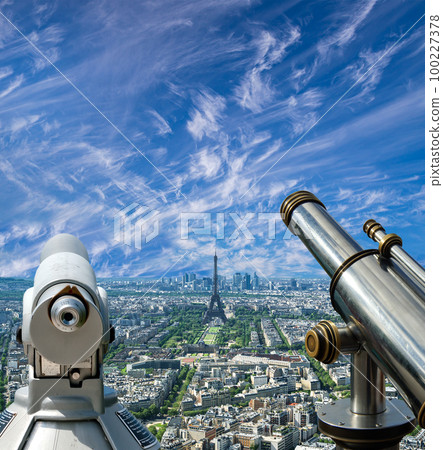 Telescope viewer and city skyline at daytime (against the background of very beautiful clouds). Paris, France. 100227378
