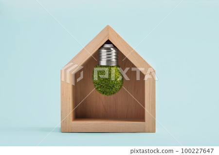 Light bulb inside house on blue background. Power energy, business idea, ecology, loan, mortgage, property or home concept. Eco friendly house, Environmental protection Light bulb inside house on blue background. Power energy, business idea, ecology, loan, mortgage, property or home concept. Eco friendly house, Environmental protection 100227647
