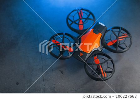 Gaming orange mini drone on a dark background Gaming orange mini drone on a dark background 100227668