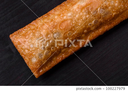 Delicious fresh crispy pie with cherry jam on a wooden cutting board Delicious fresh crispy pie with cherry jam on a wooden cutting board 100227979