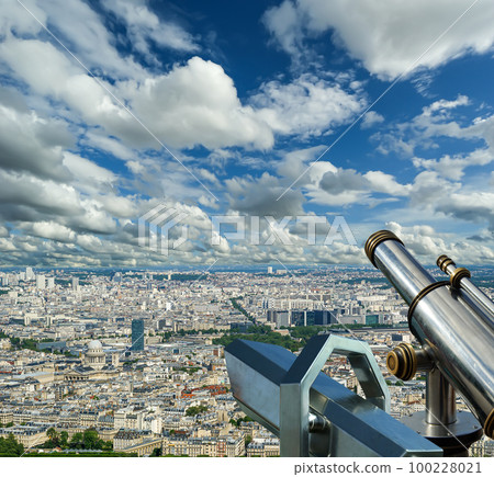 Telescope viewer and city skyline at daytime (against the background of very beautiful clouds). Paris, France. 100228021
