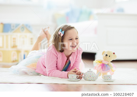 Little girl playing with doll house. Kid with toys 100228407