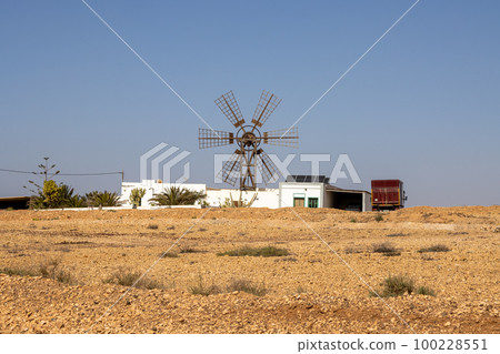 Stone desert and a windmill, Fuerteventura Stone desert and a windmill, Fuerteventura 100228551