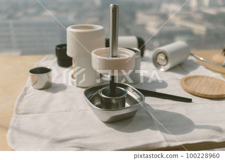 Put and temping grounded coffee into coffee basket. Put and temping grounded coffee into coffee basket. 100228960