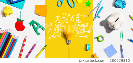 Brainstorming concept with a light bulb and school supplies 100229210