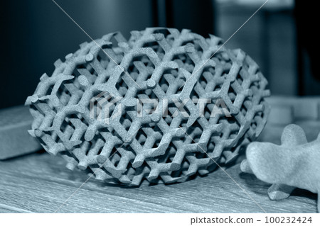 Gray object printed on powder 3D printer. Multi Jet Fusion MJF. Powder 3D printer printed three-dimensional models from polyamide powder. New modern additive 3D printing technology. Symbol innovative Gray object printed on powder 3D printer. Multi Jet Fusion MJF. Powder 3D printer printed three-dimensional models from polyamide powder. New modern additive 3D printing technology. Symbol innovative 100232424