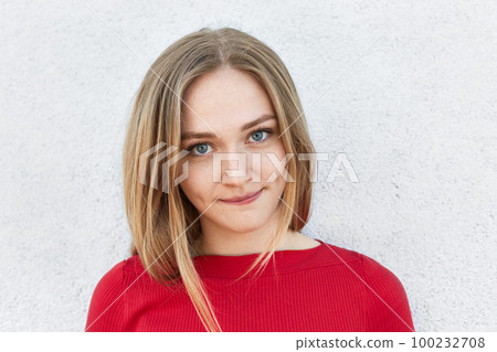 Confident woman with light hair, mesmerizing eyes and pure skin looking directly into camera. Stylish woman with freckles having certain look isolated over white studio background. Beauty concept 100232708