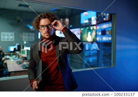 System administrator in eyeglasses in server datacenter hall 100233137