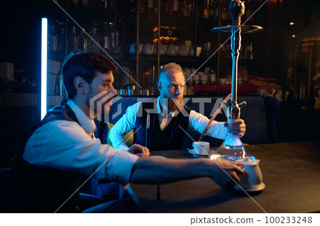 Good friends meeting in hookah lounge, relax concept Good friends meeting in hookah lounge, relax concept 100233248