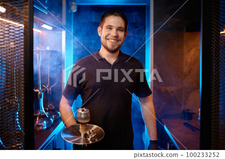 Portrait of smiling hookah man holding traditional eastern accessory for smoking 100233252