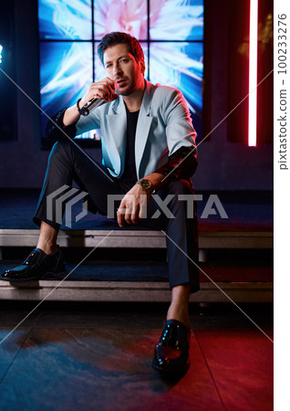 Casual singer with lyric song performing on stage 100233276