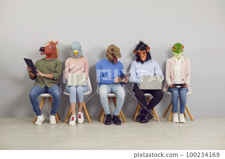 People in funny animal masks waiting in line and using laptop and tablet computers People in funny animal masks waiting in line and using laptop and tablet computers 100234169